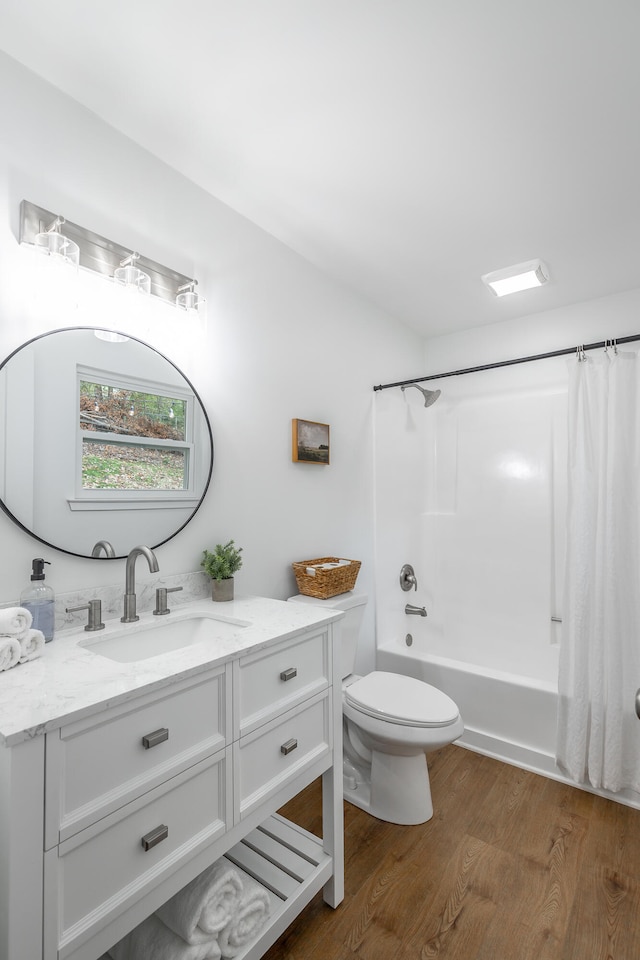 full bathroom featuring wood-type flooring, vanity, toilet, and shower / bathtub combination with curtain