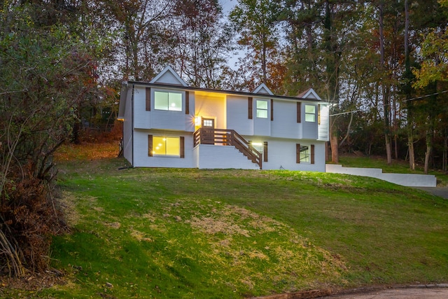 split foyer home with a front lawn