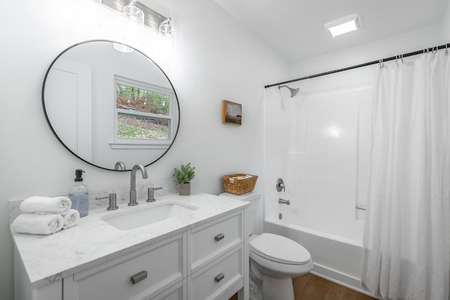 full bathroom featuring wood-type flooring, vanity, toilet, and shower / bath combo with shower curtain