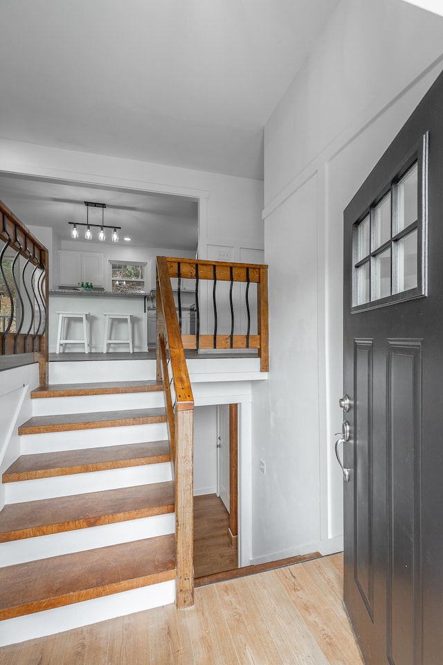 stairs with hardwood / wood-style flooring