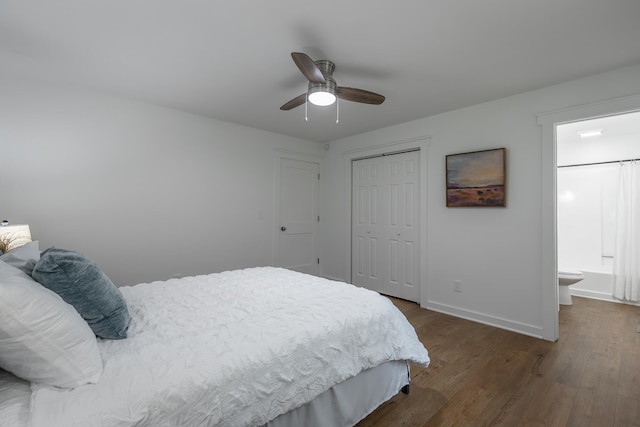 bedroom with a closet, ensuite bath, ceiling fan, and dark wood-type flooring