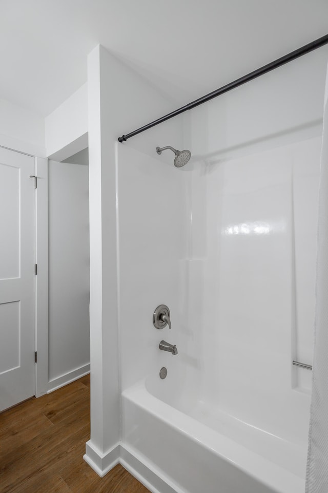 bathroom featuring shower / bath combination with curtain and wood-type flooring