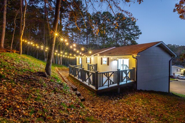 back house at dusk with a deck