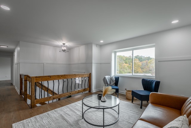 sitting room featuring hardwood / wood-style floors and a notable chandelier