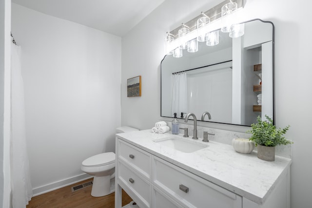 bathroom featuring toilet, vanity, a shower with shower curtain, and hardwood / wood-style flooring