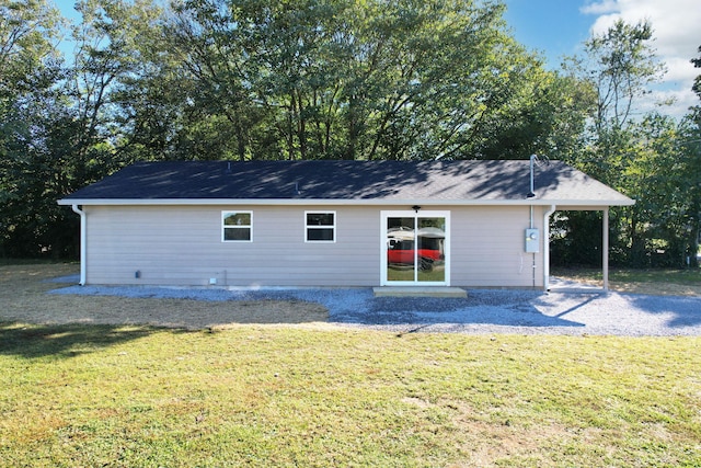 rear view of property with a lawn