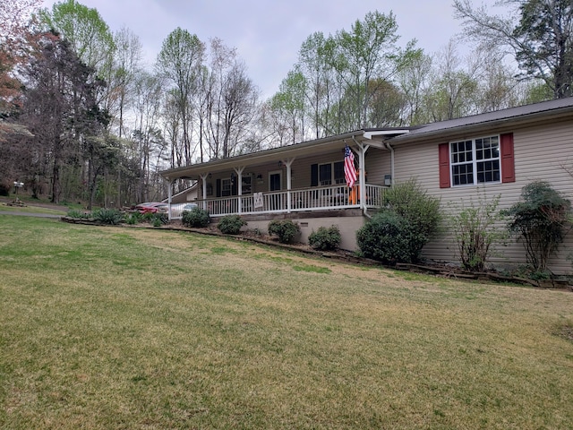 ranch-style house with a front yard and a porch