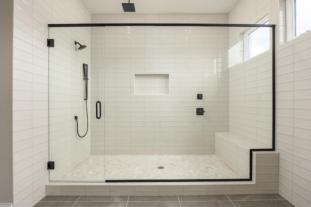 bathroom with tile patterned floors and a shower with shower door