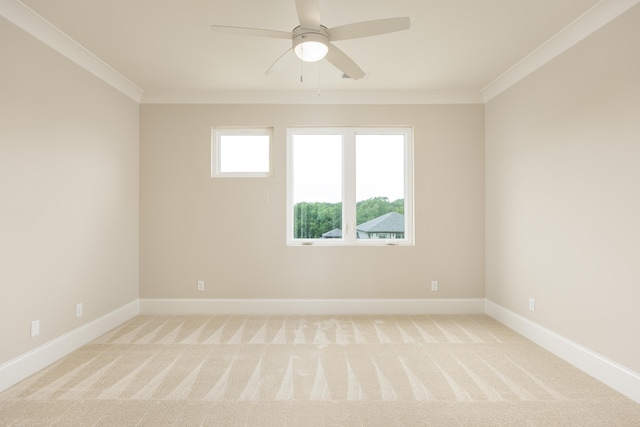 carpeted empty room featuring ceiling fan and ornamental molding