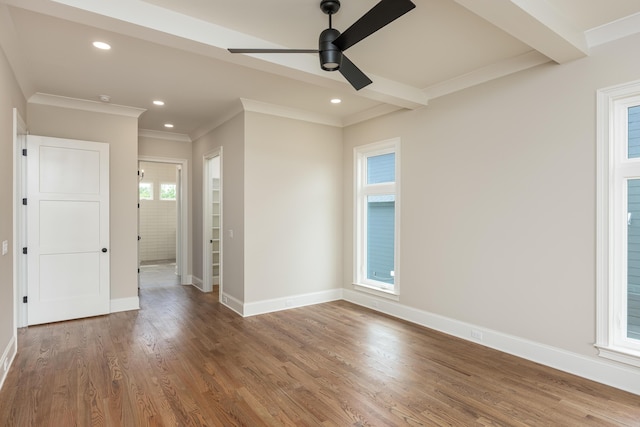 unfurnished room with ceiling fan, dark wood-type flooring, and a healthy amount of sunlight