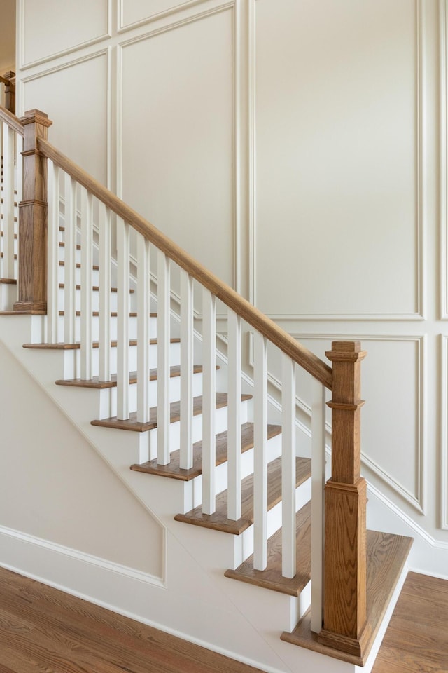 stairway with hardwood / wood-style floors