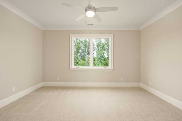 carpeted empty room with ceiling fan and ornamental molding