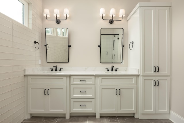 bathroom featuring tile patterned flooring, vanity, and walk in shower