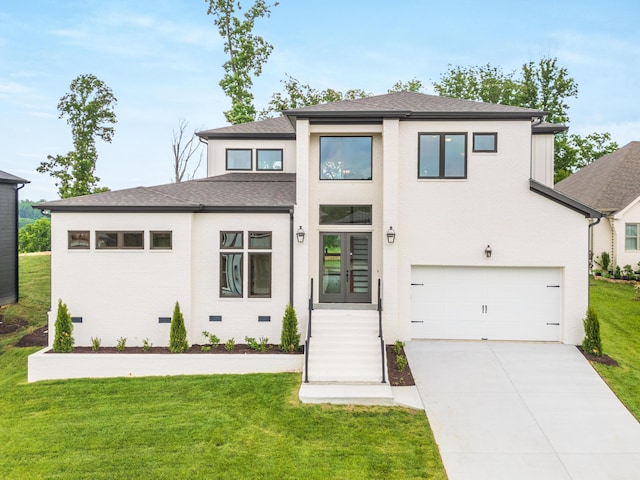 prairie-style home featuring french doors, a garage, and a front lawn