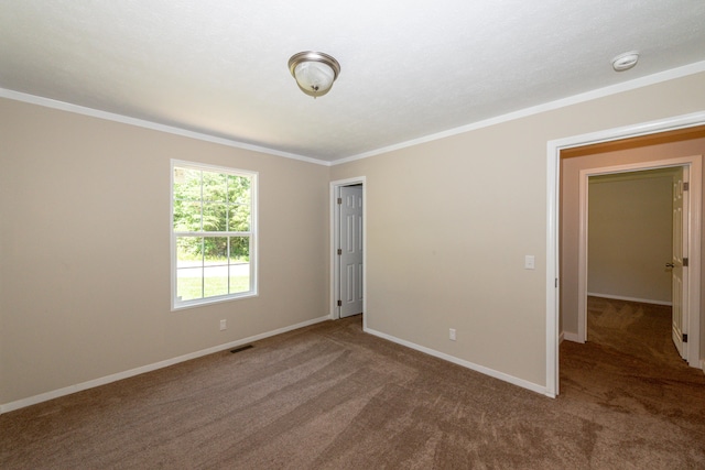 carpeted spare room featuring ornamental molding