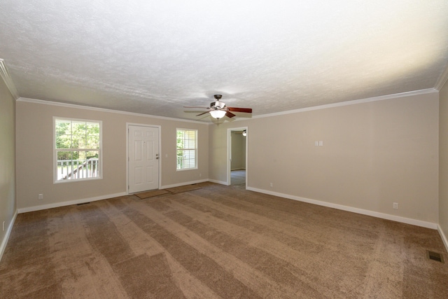 carpeted empty room with ceiling fan, ornamental molding, and a textured ceiling