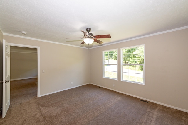 carpeted empty room featuring ceiling fan and ornamental molding