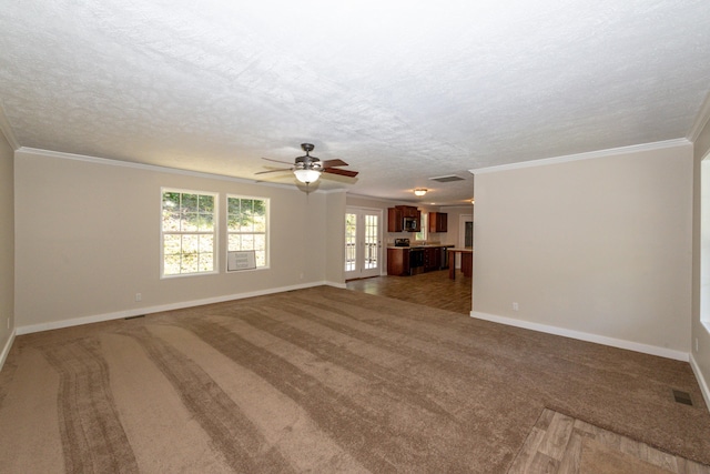 unfurnished living room featuring dark colored carpet, ornamental molding, and a textured ceiling