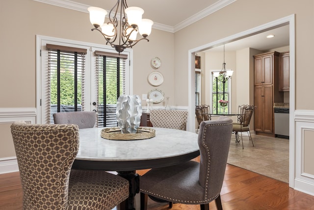 1726 Derby Ln NW, Cleveland, TN 37312 - dining area featuring a chandelier, ornamental molding, plenty of natural light, light wood-style floors, and a wainscoted wall