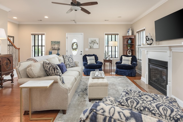 1726 Derby Ln NW, Cleveland, TN 37312 - living area featuring ceiling fan, stairway, ornamental molding, wood finished floors, and a fireplace with flush hearth
