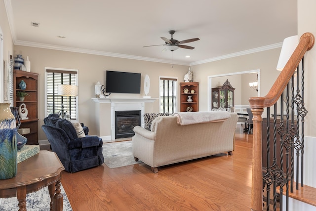 1726 Derby Ln NW, Cleveland, TN 37312 - living area featuring a glass covered fireplace, light wood finished floors, plenty of natural light, a ceiling fan, and crown molding