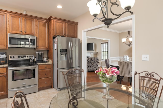 1726 Derby Ln NW, Cleveland, TN 37312 - kitchen with stainless steel appliances, a chandelier, brown cabinets, crown molding, and light stone counters