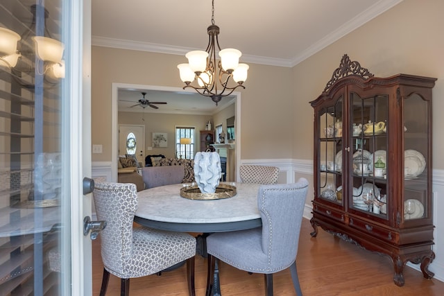 1726 Derby Ln NW, Cleveland, TN 37312 - dining space with ornamental molding, a chandelier, a wainscoted wall, wood finished floors, and ceiling fan