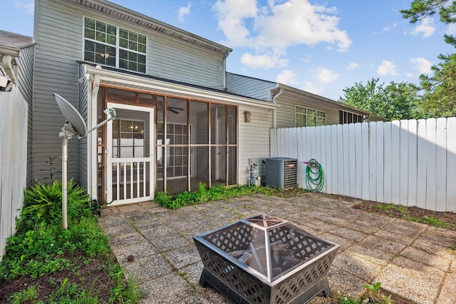 6585 Hickory Trace Cir, Chattanooga, TN 37421 - back of house featuring a fire pit, central AC unit, a patio, and a sunroom