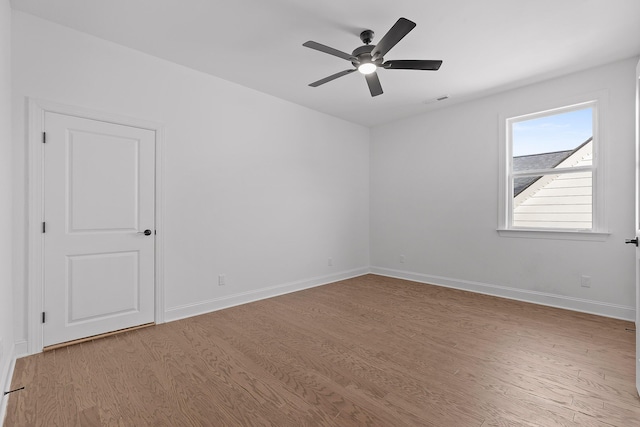 unfurnished room with ceiling fan and light wood-type flooring