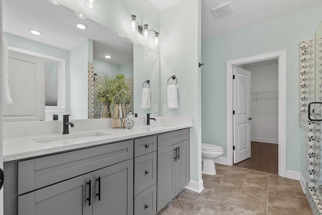 bathroom with vanity, an enclosed shower, and toilet