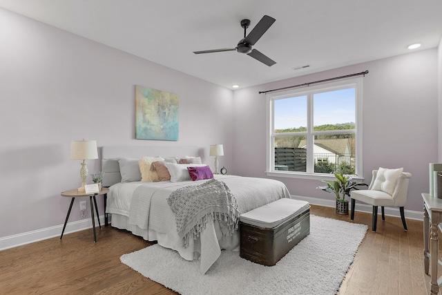 bedroom with ceiling fan and dark hardwood / wood-style floors