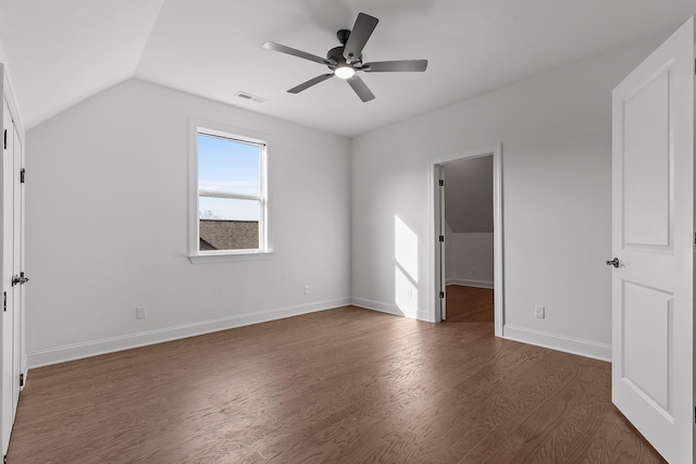 unfurnished bedroom featuring a walk in closet, ceiling fan, dark hardwood / wood-style floors, a closet, and lofted ceiling