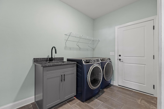 laundry area featuring sink, cabinets, and independent washer and dryer