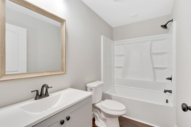 full bathroom featuring hardwood / wood-style floors, vanity, toilet, and shower / tub combination