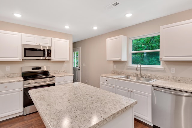 kitchen featuring a center island, a healthy amount of sunlight, sink, and stainless steel appliances