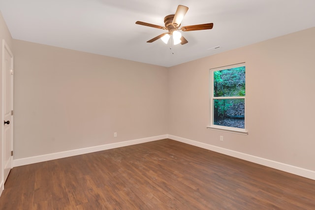 empty room featuring dark hardwood / wood-style floors and ceiling fan