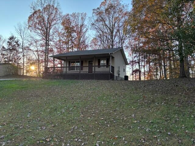 view of front of house featuring a front yard and a wooden deck