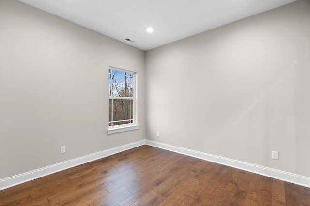 empty room featuring dark wood-type flooring