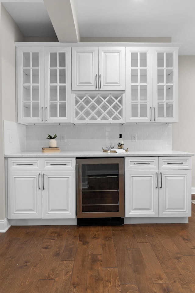 bar featuring white cabinetry, tasteful backsplash, wine cooler, and dark hardwood / wood-style flooring