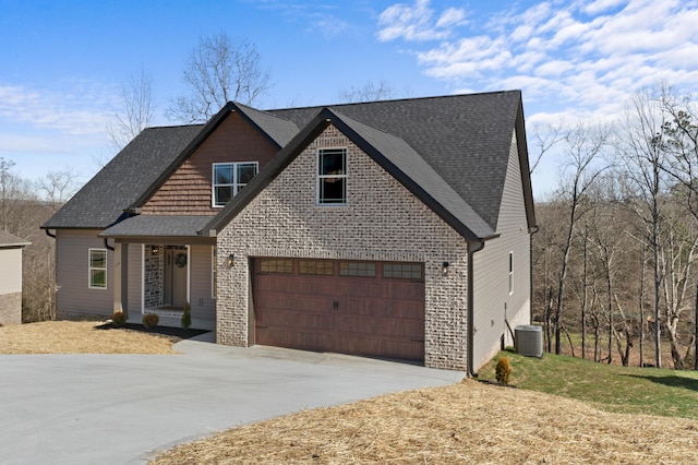 view of front of house featuring a garage and central AC