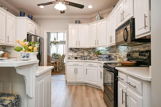 1967 Weston Hills Dr NW, Cleveland, TN 37312 - kitchen featuring black appliances, a ceiling fan, white cabinetry, decorative backsplash, and ornamental molding