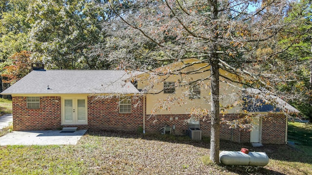 view of front of home featuring a patio area, french doors, and a front yard