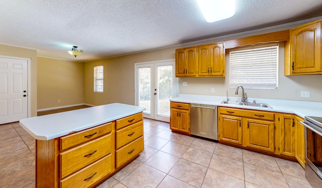 kitchen with french doors, a textured ceiling, stainless steel appliances, sink, and light tile patterned floors