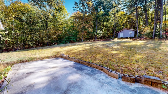 view of yard with an outbuilding and a patio