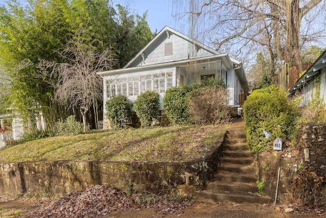 view of side of property featuring a sunroom