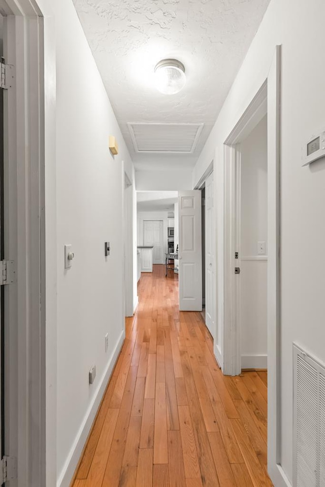 5027 Fanchers Mill Rd, Sparta, TN 38583 - hallway with attic access, light wood-style floors, and baseboards