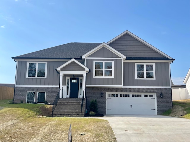 bi-level home with a front lawn and a garage