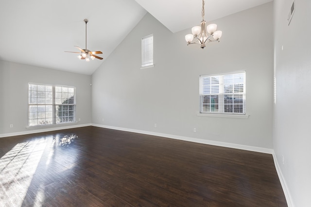 empty room with ceiling fan with notable chandelier, dark wood-type flooring, and high vaulted ceiling