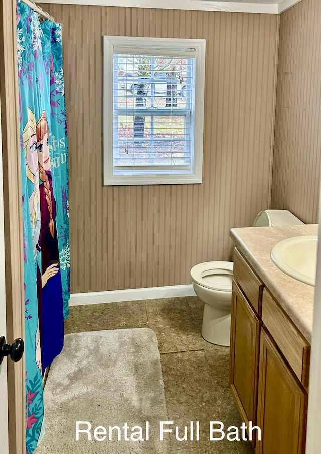 bathroom featuring tile patterned flooring, vanity, and toilet