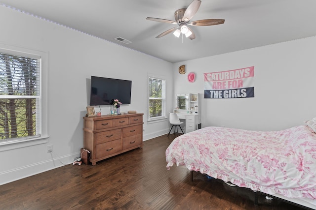 bedroom with multiple windows, ceiling fan, and dark wood-type flooring